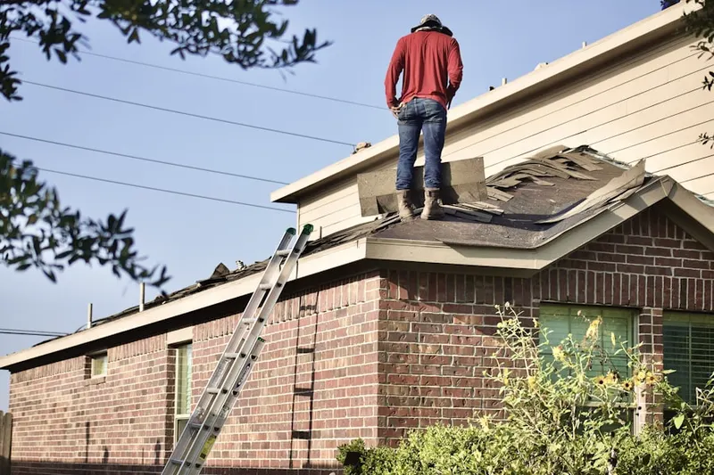 Professional roofer working on a residential roof in Wellshire